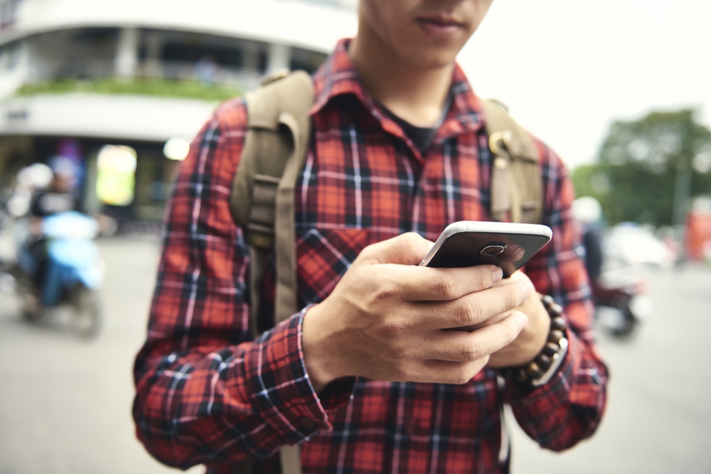A person using a mobile phone outdoors, as pictured on the original press listing.